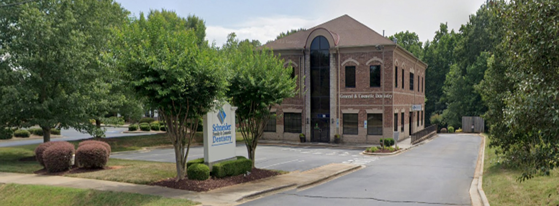 The image shows a modern dental clinic interior with various pieces of equipment, including a dental chair and an X-ray machine.